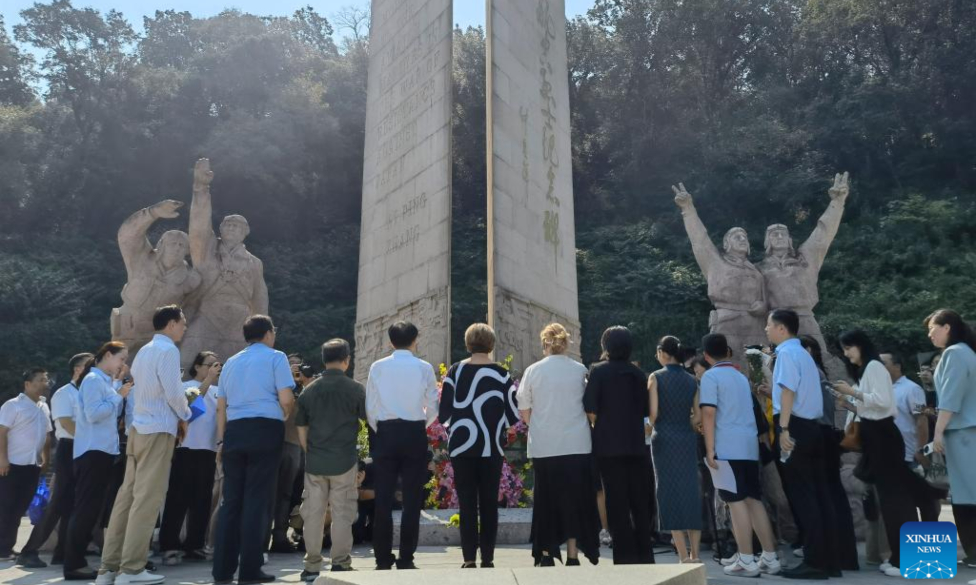 This mobile phone photo taken on Sept. 5, 2025 shows visitors including Nell Chennault Calloway, granddaughter of Claire Lee Chennault, paying tribute at the Nanjing Anti-Japanese Aviation Martyrs Memorial Hall in east China's Jiangsu Province, Sept. 5, 2025. (Xinhua/Qiu Bingqing)