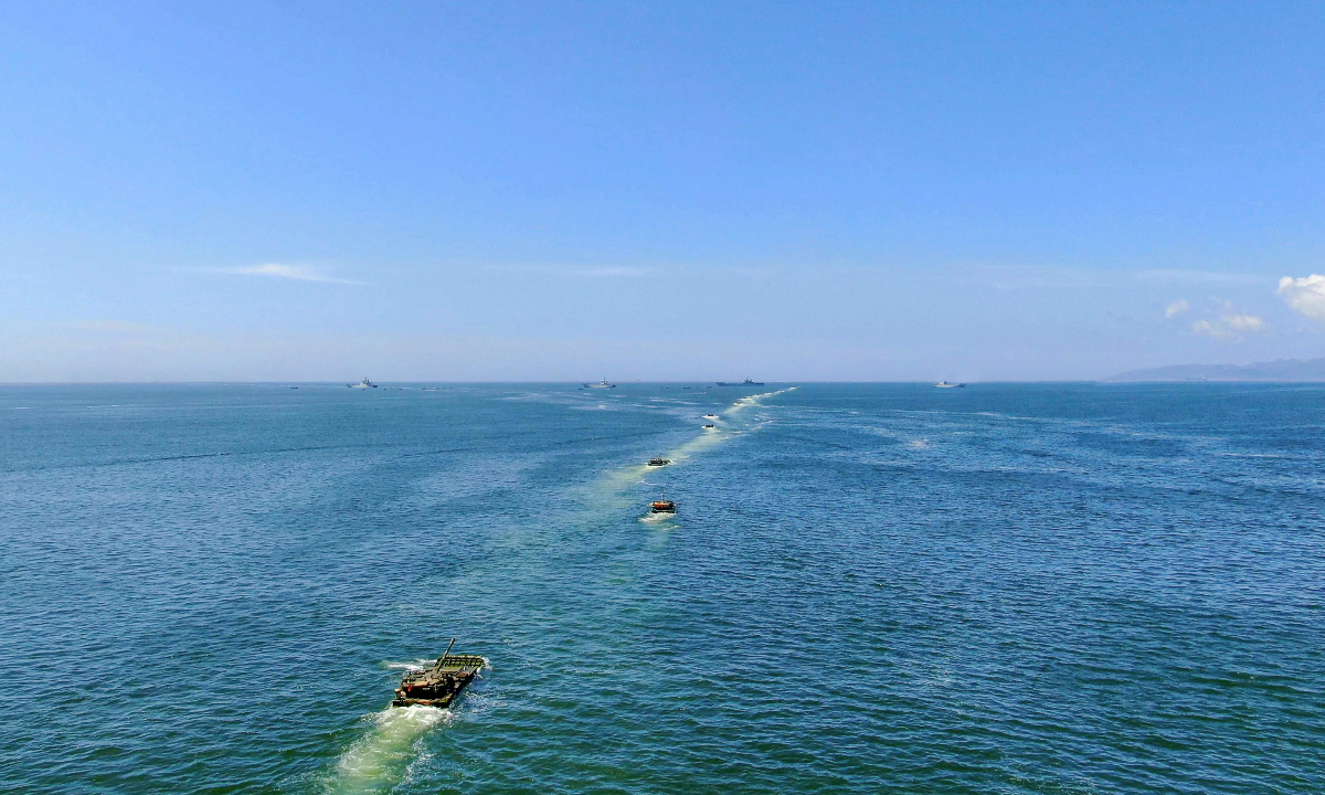 Amphibious armored infantry fighting vehicles (IFVs) attached to a brigade under the Chinese PLA Army maneuver towards the designated sea area during a ferrying and assault wave formation training exercise. (eng.chinamil.com.cn/Photo by Zhang Mao)