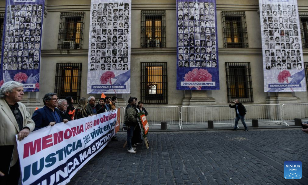 People attend an event to pay homage to former Chilean President Salvador Allende and to commemorate the 52nd anniversary of the military coup against Allende, near La Moneda Palace in Santiago, capital of Chile, Sept. 11, 2025. Then-Commander-in-chief of the Chilean army Augusto Pinochet launched a military coup to overthrow the democratically-elected government of Allende on Sept. 11, 1973. Allende was killed during the coup, marking the beginning of a 17-year period of military regime in Chile. (Photo by Jorge Villegas/Xinhua)
