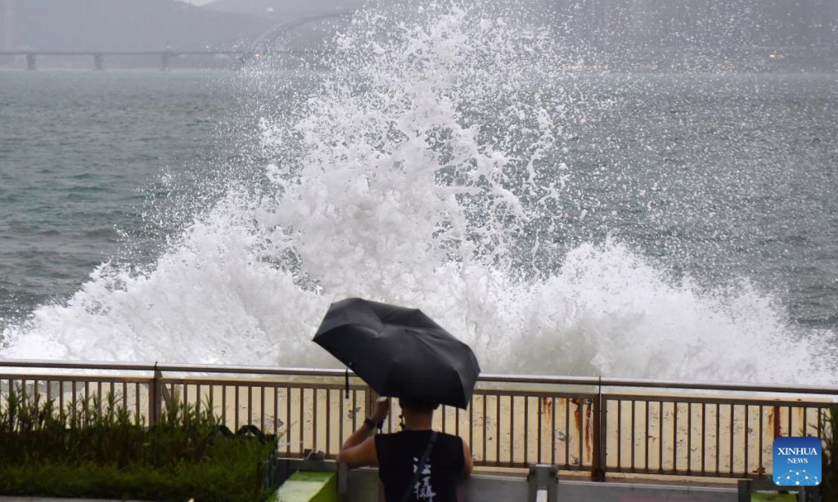 A man takes photos of a wave by a coast in Hong Kong, south China, Sept. 23, 2025. (Xinhua/Chen Duo)