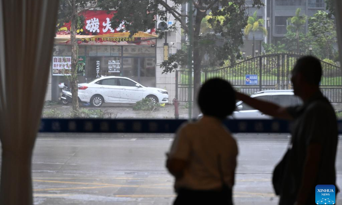 People look out of a window at a hotel in Yangjiang City, south China's Guangdong Province, on Sept. 24, 2025. Typhoon Ragasa, the 18th typhoon of 2025, made landfall in south China's Guangdong Province at about 5 p.m. on Wednesday, according to the provincial meteorological observatory. The typhoon, with maximum wind force near its center reaching 40 meters per second, churned ashore at Hailing Island in the city of Yangjiang in Guangdong. (Xinhua/Deng Hua)