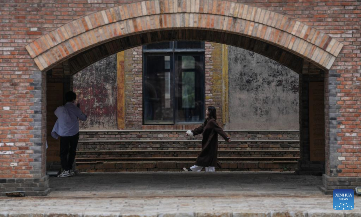 People take photos at a cultural and creative site, which is transformed from an abandoned factory, in Shenyang, capital of northeast China's Liaoning Province, Oct. 6, 2025. Many industrial heritages in Shenyang of northeast China's Liaoning Province have been transformed into public leisure spaces, creative industry parks, and distinctive neighborhoods, offering citizens and tourists unique experiences during this year's National Day and Mid-Autumn Festival holiday. (Xinhua/Pan Yulong)