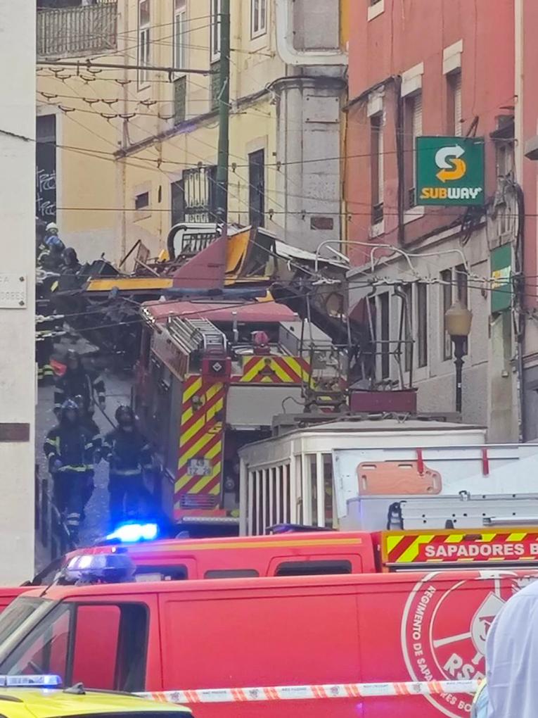 This photo taken with a mobile phone shows firefighters and Public Security Police working on the site of the funicular accident in Lisbon, Portugal, on Sept. 3, 2025. (Xinhua/Xun Wei)