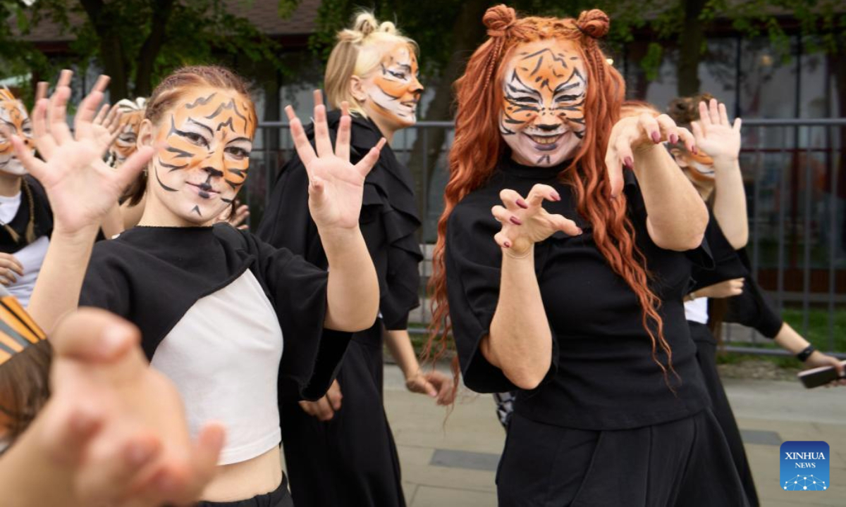 People participate in the Tiger Day costume parade in Vladivostok, Russia, Sept. 28, 2025. Since 2000, Vladivostok has celebrated Tiger Day in the last weekend of September each year to raise public awareness about tiger conservation. (Photo by Guo Feizhou/Xinhua)