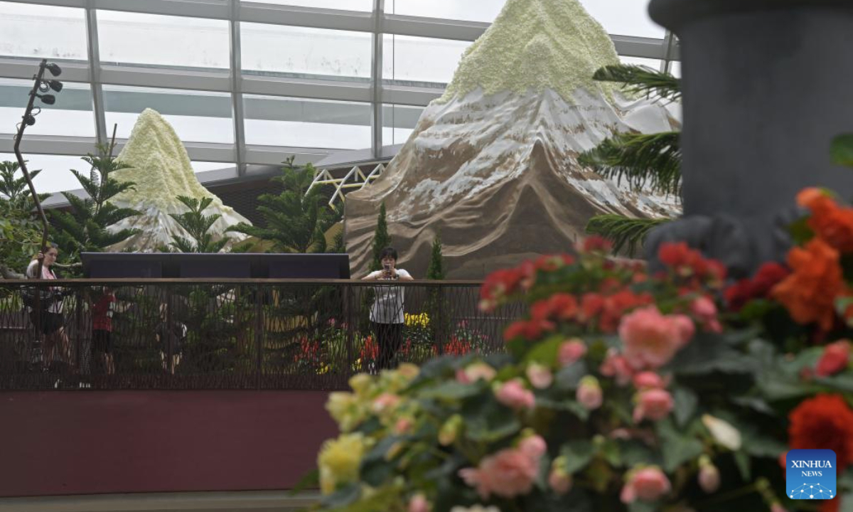 People visit an alpine adventure themed floral display at the Singapore's Gardens by the Bay on Sept. 8, 2025. (Photo by Then Chih Wey/Xinhua)