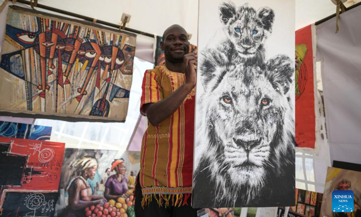An exhibitor displays paintings with African characteristics at the 15th edition of the Magical Kenya Travel Expo in Nairobi, Kenya, Oct. 2, 2025. Kenya is hosting the three-day expo, running until Friday, which has attracted 6,500 delegates from 40 countries, including tourism ministers, city mayors, investors, travel enthusiasts, and promoters. (Xinhua/Yang Guang)