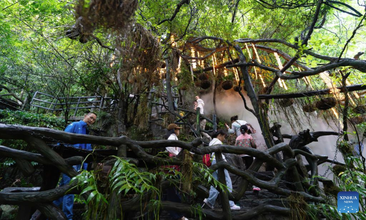 Tourists visit a scenic area themed on dendrobium officinale health tourism in Liulangcheng Village of Guangnan County, Wenshan Zhuang and Miao Autonomous Prefecture, southwest China's Yunnan Province, Aug. 27, 2025. By adopting an integrated industrial model connecting companies, cooperatives, production bases, and farmers, Guangnan County has established a comprehensive development framework centered on dendrobium officinale, a valuable Chinese herbal medicine. The framework spans cultivation, processing, sales, and health tourism, boosting local farmers' income. (Xinhua/Gao Yongwei)