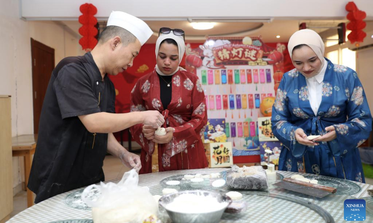 Workers learn to make moon cakes during a Mid-Autumn Festival celebration at the Central Business District (CBD) in the New Administrative Capital, east of Cairo, Egypt, on Sept. 28, 2025. The Egyptian branch of China State Construction Engineering Corporation (CSCEC) on Sunday held an event to celebrate the upcoming traditional Chinese Mid-Autumn Festival at the CSCEC-built CBD, where CSCEC's workers from China and Egypt experience rich festival cultures, such as the making of traditional Chinese lanterns and moon cakes. (Xinhua/Sui Xiankai)
