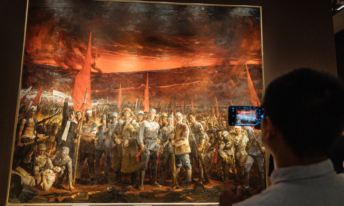 A visitor takes photos of a painting at an art exhibition commemorating the 80th anniversary of the victory in the Chinese People's War of Resistance against Japanese Aggression and the World Anti-Fascist War at the National Art Museum of China in Beijing on August 25, 2025. Photo: Li Hao/GT