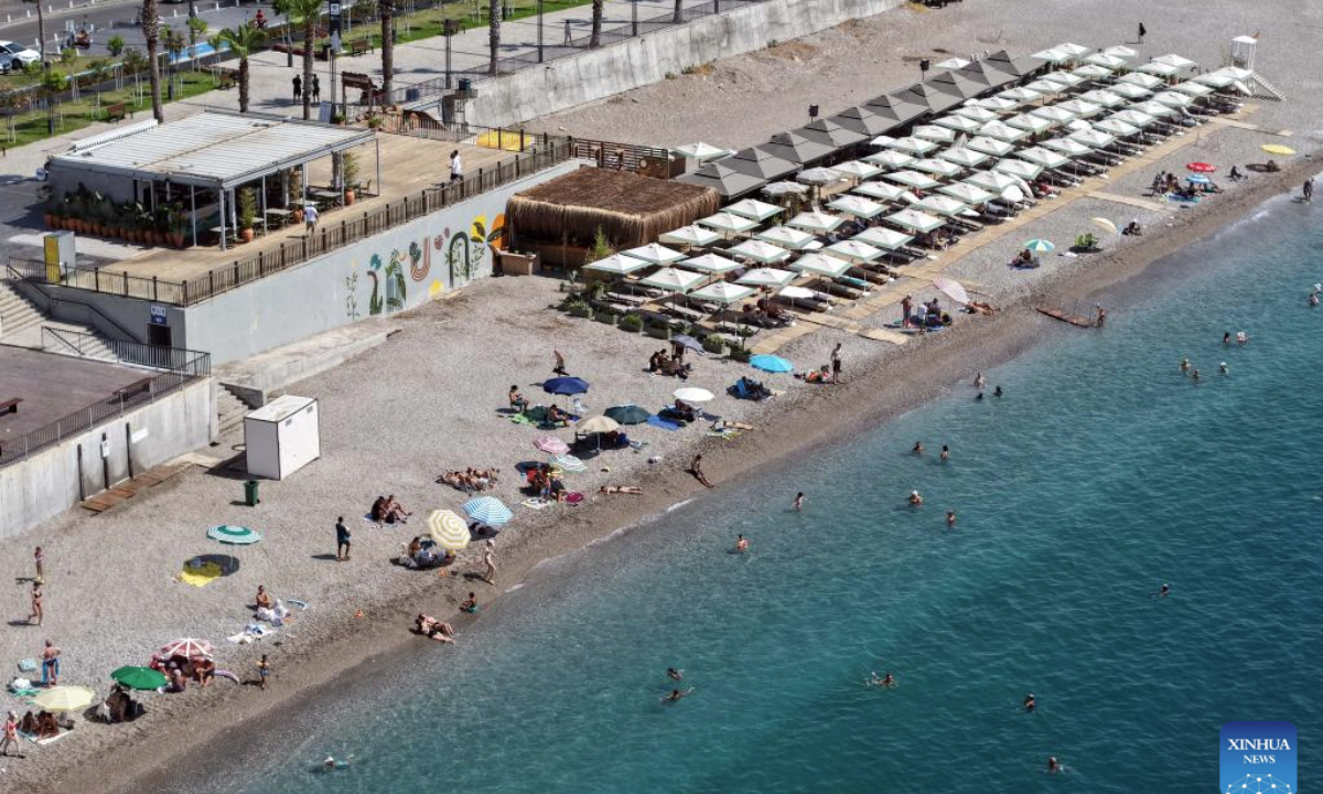 An aerial drone photo taken on Sept. 28, 2025 shows people enjoying leisure time on the beach of Konyaalti in Antalya, Türkiye. As a Türkiye's Mediterranean resort city, Antalya is famous for its endless turquoise waters and natural beauties. (Mustafa Kaya/Handout via Xinhua)

