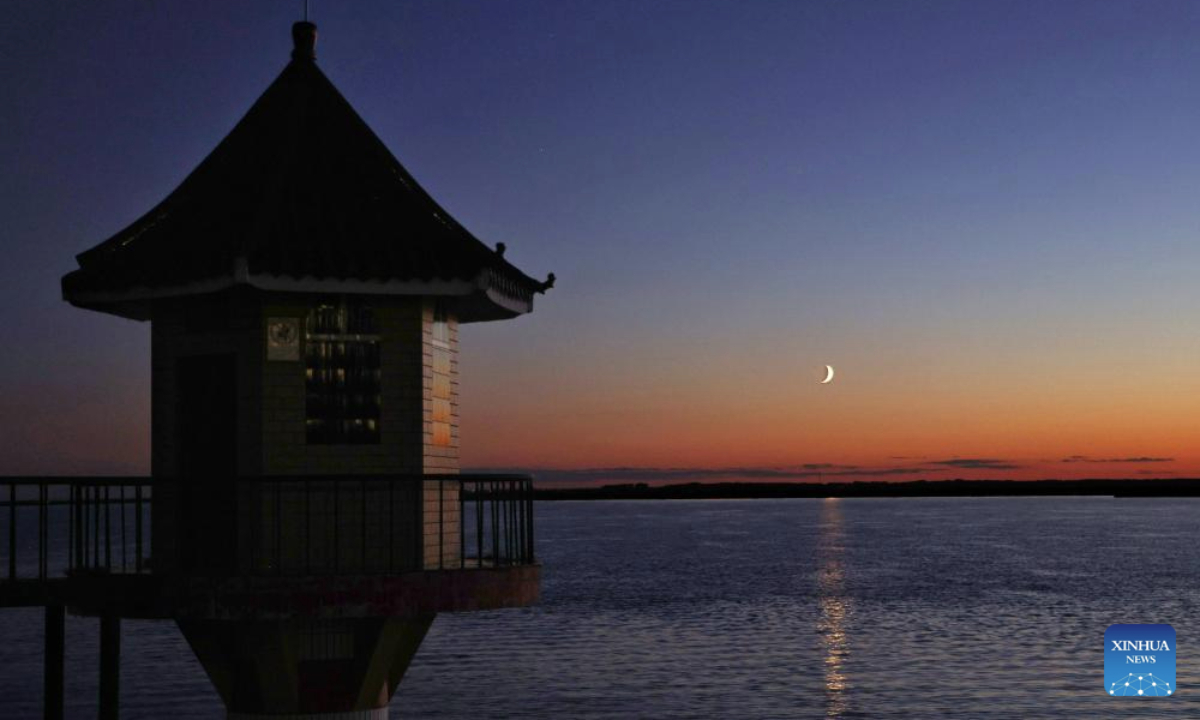 A crescent moon is seen in the sky over Tongjiang, Jiamusi City of northeast China's Heilongjiang Province, Sept. 26, 2025. (Photo by Liu Wanping/Xinhua)