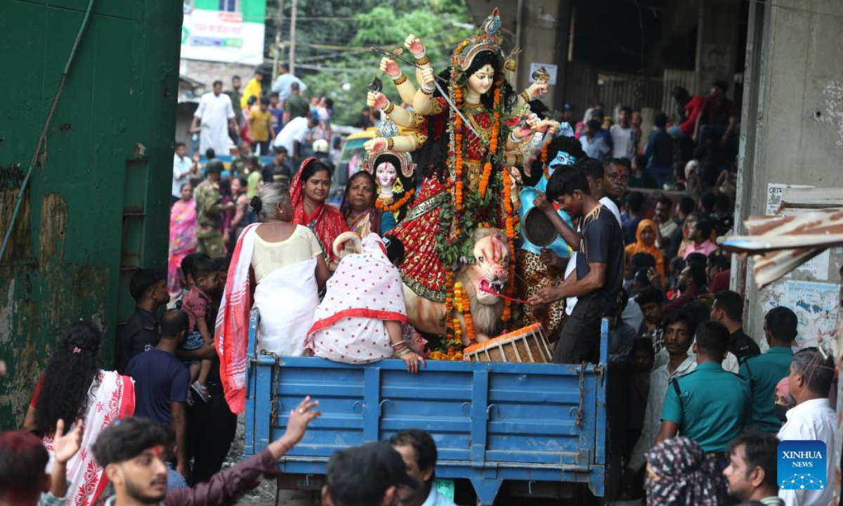 One Durga idol is being transferred in a truck for immersion in Dhaka, Bangladesh, on Oct. 2, 2025. Durga Puja, one of the largest Hindu festivals, ended in Bangladesh with the immersion of the idols on Thursday. The five-day Durga Puja festival involves the worship of Goddess Durga symbolizing the power and triumph of good over evil in Hindu mythology. After worshiping for days, devotees with tears in their eyes on Thursday bade goodbye to their beloved goddess Durga as her idols were immersed in ponds, lakes and rivers on the fifth day, marking the end of the goddess's annual stay at her paternal home. (Photo by Habibur Rahman/Xinhua)
