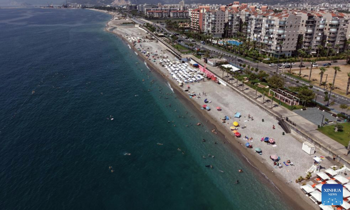 An aerial drone photo taken on Sept. 28, 2025 shows people enjoying leisure time on the beach of Konyaalti in Antalya, Türkiye. As a Türkiye's Mediterranean resort city, Antalya is famous for its endless turquoise waters and natural beauties. (Mustafa Kaya/Handout via Xinhua)