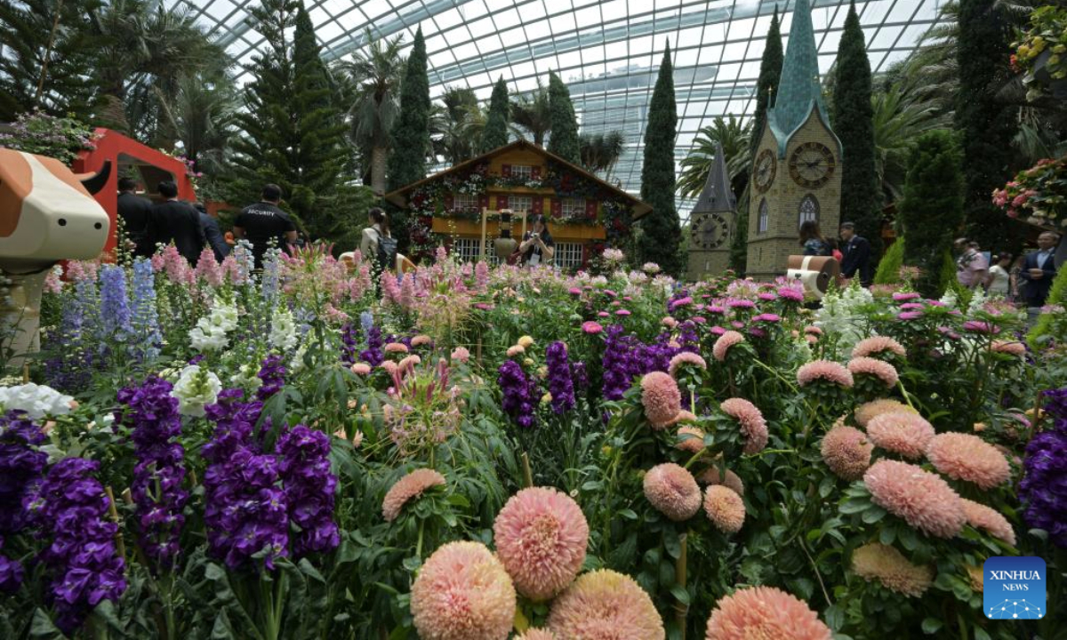 People visit an alpine adventure themed floral display at the Singapore's Gardens by the Bay on Sept. 8, 2025. (Photo by Then Chih Wey/Xinhua)