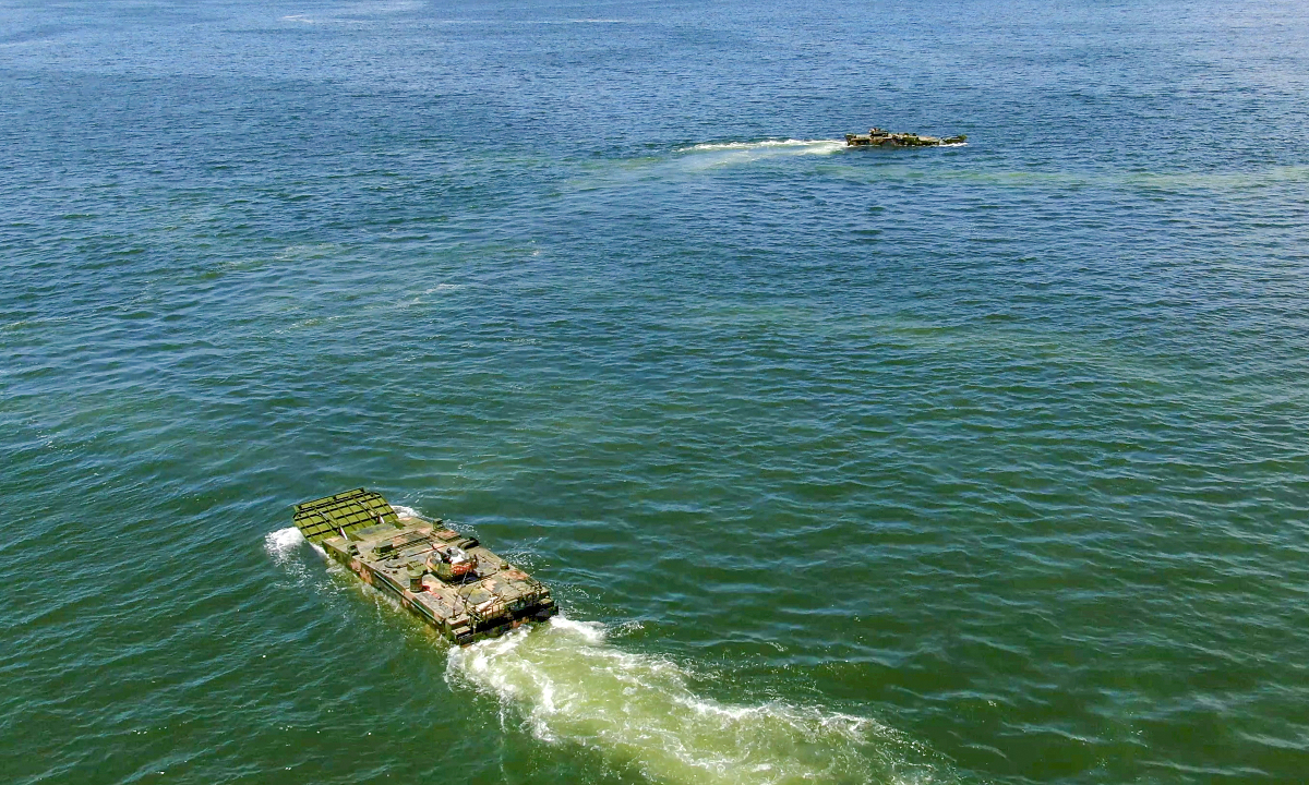 Amphibious armored infantry fighting vehicles (IFVs) attached to a brigade under the Chinese PLA Army maneuver towards the designated sea area during a ferrying and assault wave formation training exercise. (eng.chinamil.com.cn/Photo by Zhang Mao)