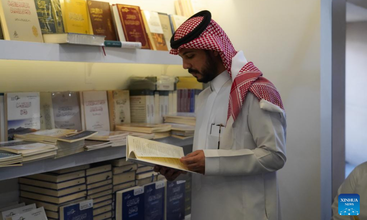 A man reads a book at the Riyadh International Book Fair 2025 in Riyadh, Saudi Arabia, Oct. 2, 2025. The book fair opened here on Thursday, bringing together over 2,000 local and international publishing houses from more than 25 countries, along with a range of cultural institutions. (Xinhua/Luo Chen)