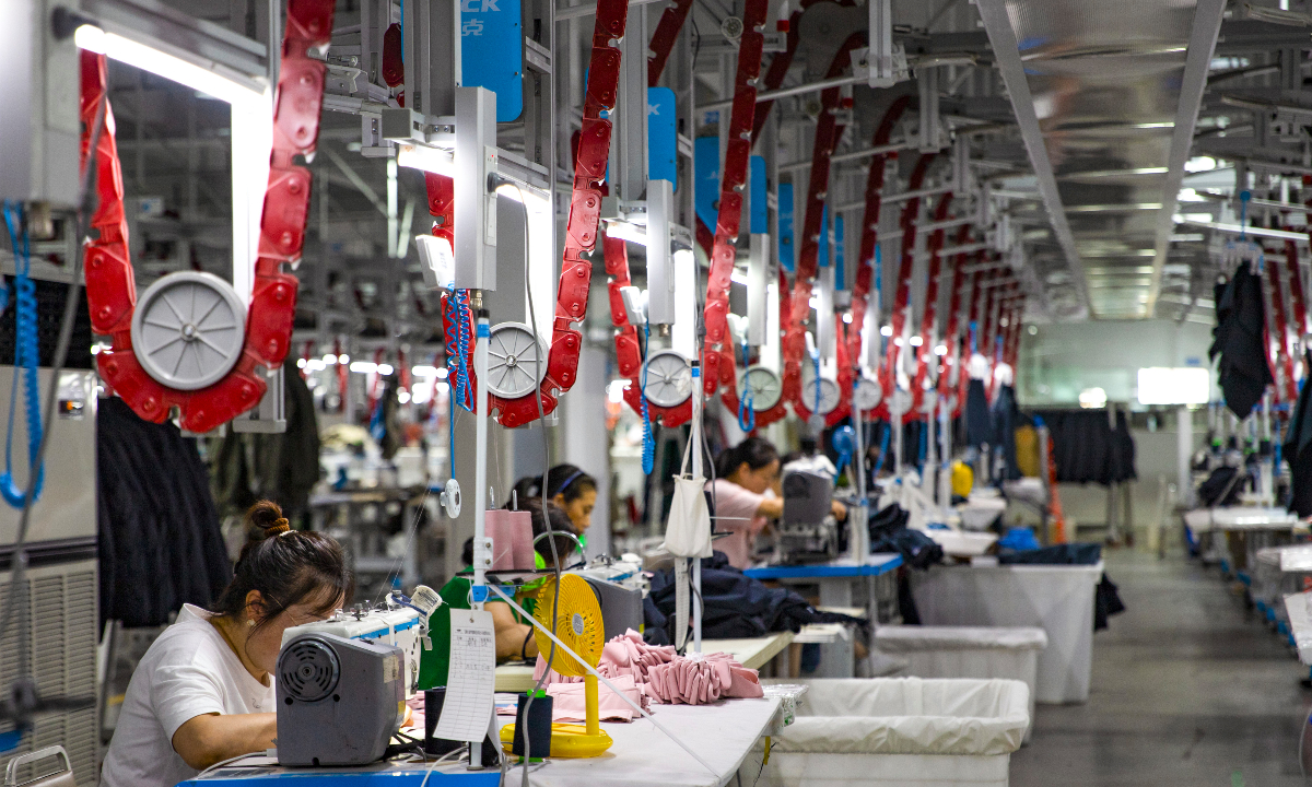 Workers at a garment company in Suncun Town, East China's Anhui Province, rush to complete foreign trade orders on October 10, 2025. The town, home to over 230 garment enterprises, is a 