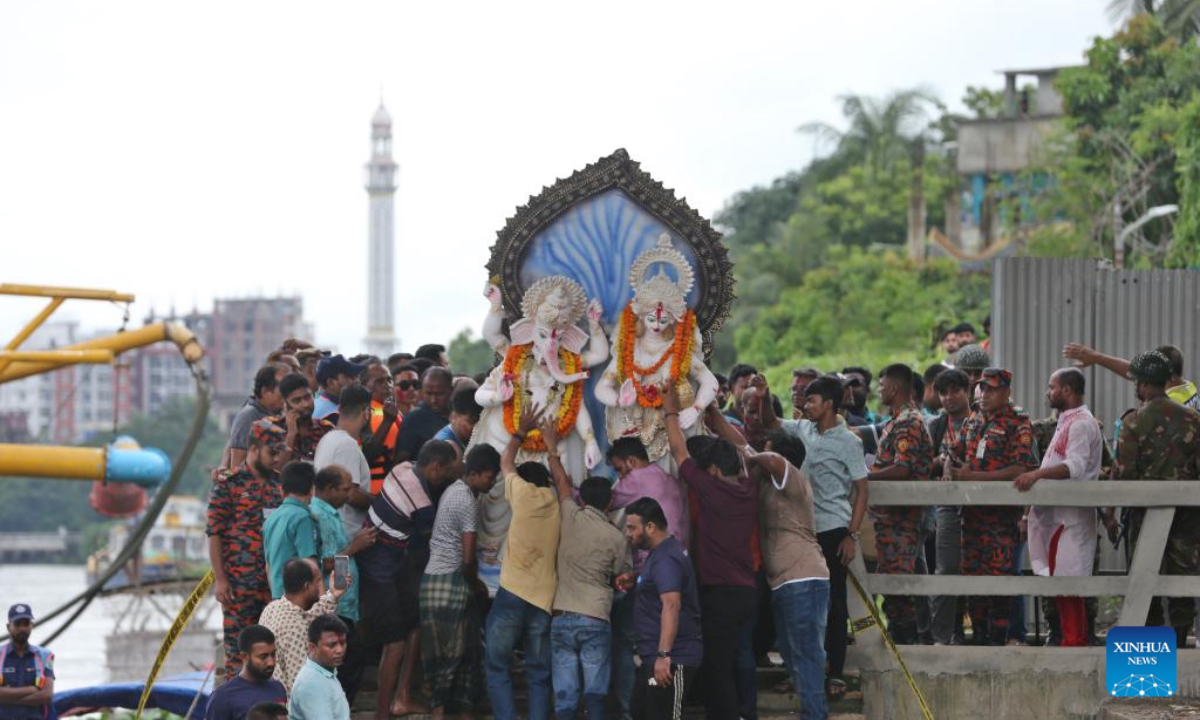 Devotees immerse one Durga idol in the Buriganga river in Dhaka, Bangladesh, on Oct. 2, 2025. Durga Puja, one of the largest Hindu festivals, ended in Bangladesh with the immersion of the idols on Thursday. The five-day Durga Puja festival involves the worship of Goddess Durga symbolizing the power and triumph of good over evil in Hindu mythology. After worshiping for days, devotees with tears in their eyes on Thursday bade goodbye to their beloved goddess Durga as her idols were immersed in ponds, lakes and rivers on the fifth day, marking the end of the goddess's annual stay at her paternal home. (Photo by Habibur Rahman/Xinhua)