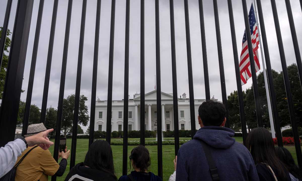 People take photos after the American flag on the North Lawn at the White House in Washington, is lowered to half-staff after Charlie Kirk, the CEO and co-founder of Turning Point USA, was killed at an event in Orem, Utah, Wednesday, Sept. 10, 2025. Photo: VCG