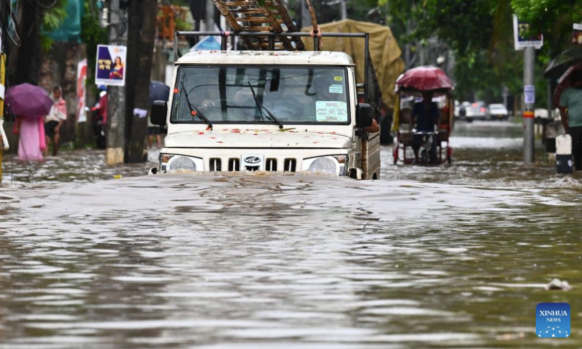 A vehicle wades through floodwaters after heavy monsoon rain in Guwahati city of India's northeastern state of Assam, Sept. 16, 2025. (Str/Xinhua)
