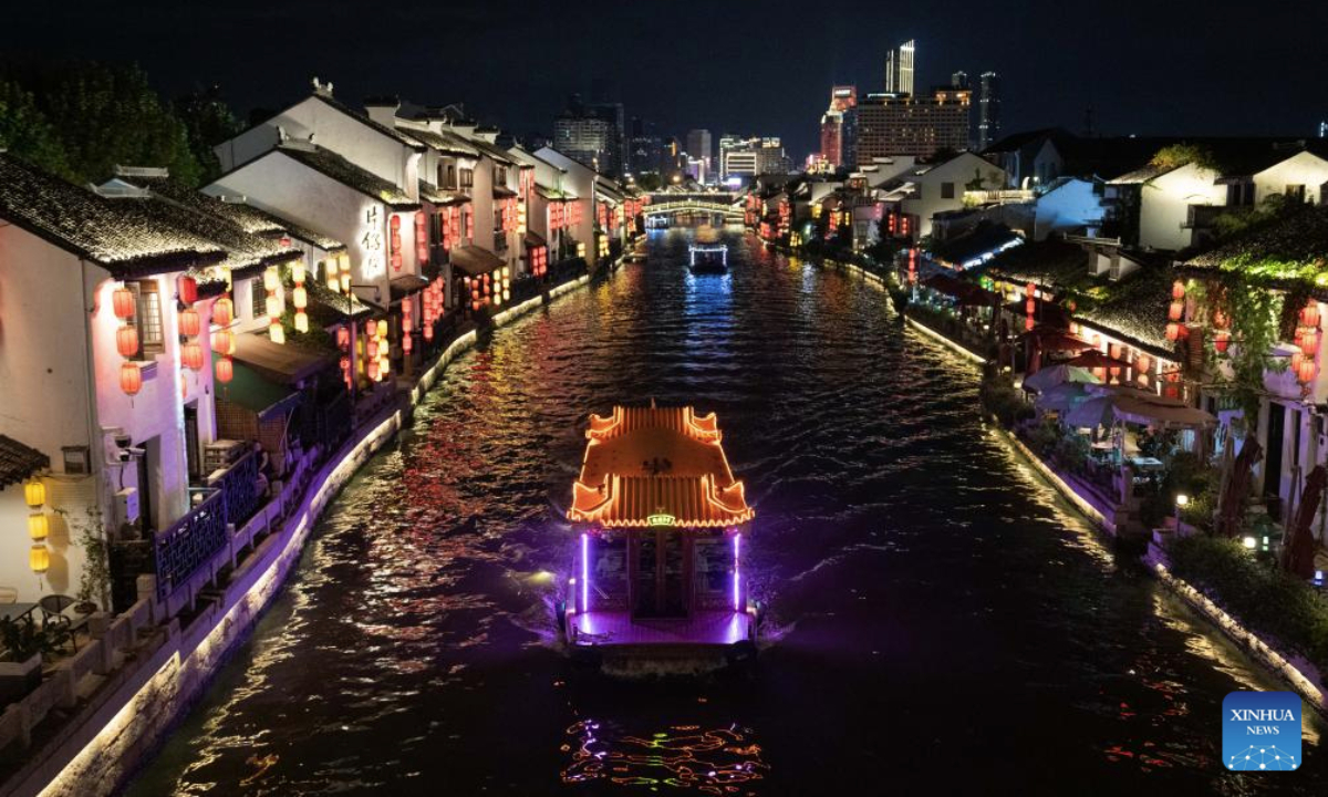 Sightseeing boats sail on the ancient canal in Wuxi City, east China's Jiangsu Province, Sept. 23, 2025. The Qingming bridge historical and cultural community spreads across the ancient canal, and boasts rich heritages. It is attracting an increasing number of visitors as more modern technologies have been adopted for enhanced sensory experiences. (Xinhua/Hu Zhixuan)