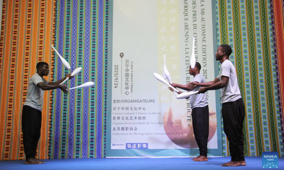Local artists perform acrobatic stunts during the Mid-Autumn Festival celebration at the Chinese Cultural Center of Benin in Cotonou, Benin, Sept. 24, 2025. A Mid-Autumn Festival celebration was held at the Chinese Cultural Center of Benin on Wednesday. The event, featuring a photo exhibition, mooncake tasting, dance and acrobatic performances, attracted 180 guests from various circles. (Photo by Seraphin Zounyekpe/Xinhua)