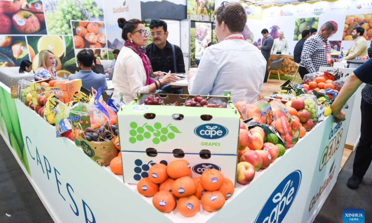 People communicate during the Fruit Attraction in Madrid, Spain, Oct. 2, 2025. The event was held here from Sept. 30 to Oct. 2 this year. (Photo by Gustavo Valiente/Xinhua)