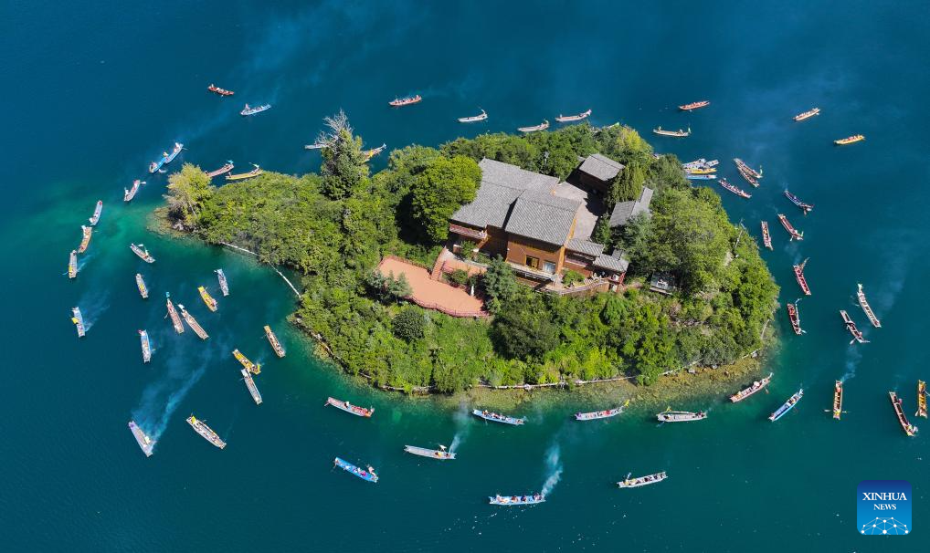An aerial drone photo taken on Sept. 16, 2025 shows local people sailing around an island while circling the lake by boat in Yanyuan County of Liangshan Yi Autonomous Prefecture, southwest China's Sichuan Province. The first mountain and lake circling festival of Lugu Lake kicked off at Liangshan Yi Autonomous Prefecture on Tuesday. Mountain and lake circling is an important folk custom of the Mosuo people living near Lugu Lake. Starting this year, Liangshan Prefecture has officially designated the 25th day of the seventh lunar month as the mountain and lake circling festival, making it a local statutory holiday. Residents of Yanyuan and Muli counties can enjoy a one-day exclusive holiday. (Photo by Zeng Chengxu/Xinhua)