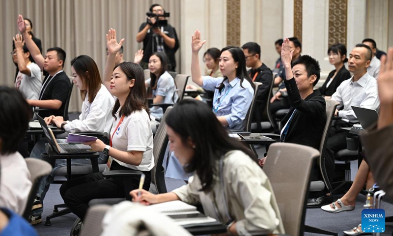 Media professionals work at a press conference held by the State Council Information Office (SCIO) on China Customs' achievements in safeguarding borders and promoting high-quality development in the 14th Five-Year Plan period (2021-2025) in Beijing, capital of China, Aug. 25, 2025. (Xinhua)