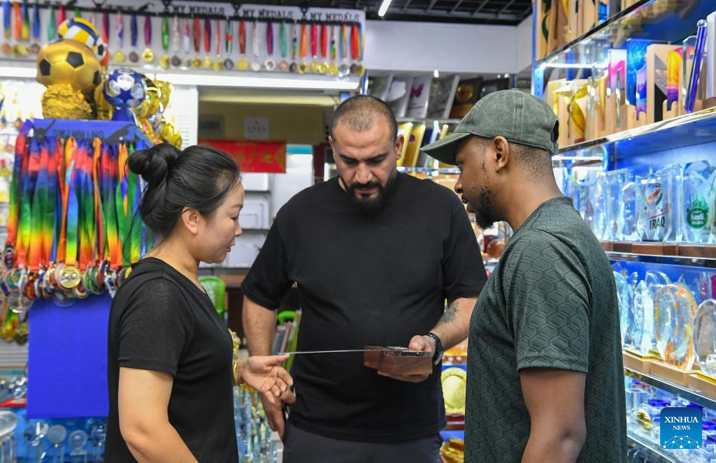 Foreign clients purchase sports goods at Yiwu International Trade City in Yiwu, east China's Zhejiang Province, Sept. 15, 2025. China's Yiwu, dubbed the world's supermarket, has recently witnessed a surge in orders for sports products, driven by major sporting events including the upcoming 2026 FIFA World Cup. (Photo by Shi Kuanbing/Xinhua)