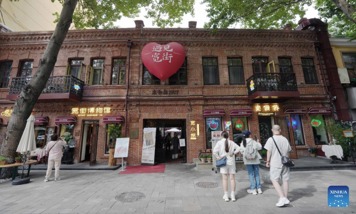 Visitors are seen in front of the Kuanjie Street Museum in Harbin, northeast China's Heilongjiang Province, Sept. 3, 2025. Harbin is home to various non-profit private museums with rich collections of cultural relics and historical archive which bear witness to the evolution of a city at the forefront of the East-West cultural exchange. (Xinhua/Wang Song)