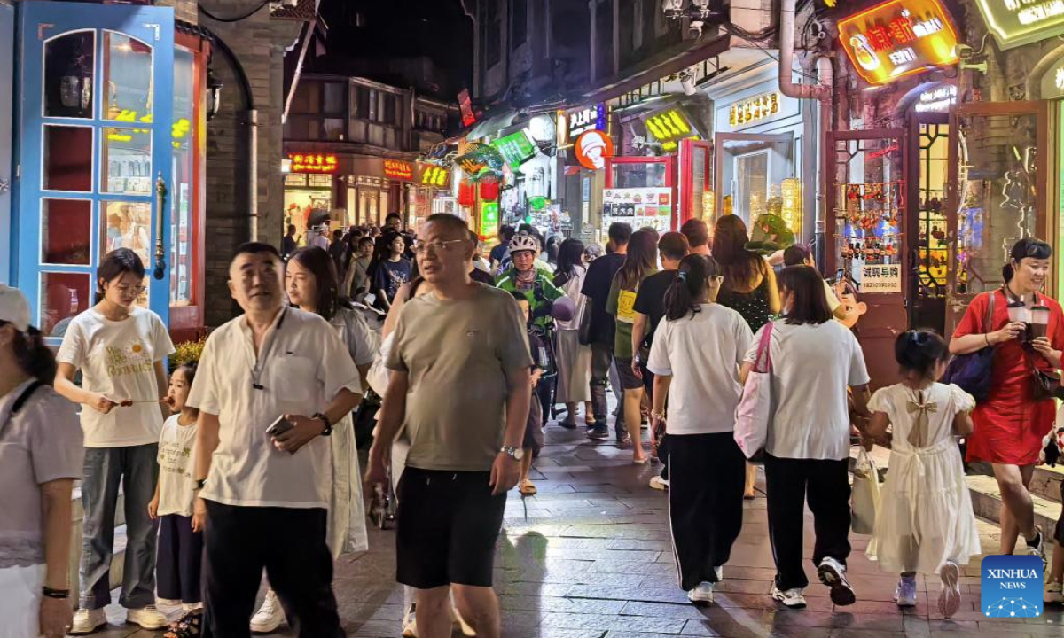 People walk at a pedestrian street near Shichahai scenic area in Beijing, capital of China, July 30, 2025. Beijing has vigorously developed its night economy since the beginning of this summer, featuring local cuisine, outdoor films, music festivals, and night markets. Photo:Xinhua