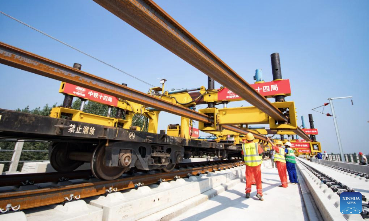 Workers operate at the track laying construction site of the Xiong'an-Shangqiu high-speed railway in Hejian city, north China's Hebei Province, Sept. 1, 2025. Track-laying operation officially kicked off on Monday throughout the Xiong'an-Shangqiu high-speed railway. With a designed speed of 350 km per hour, the 552-kilometer-long railway will connect Xiong'an in north China's Hebei Province and Shangqiu in central China's Henan Province after completion. (Photo by Yuan Ruiyu/Xinhua)