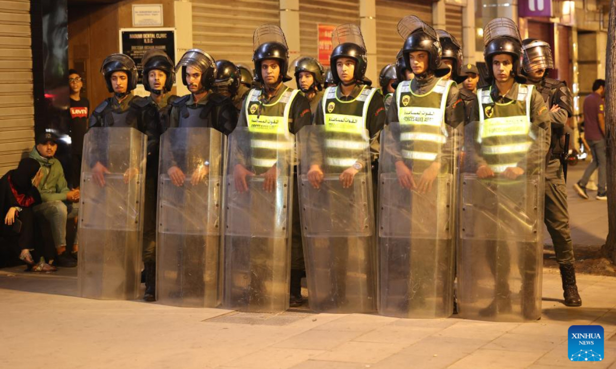 Security forces stand guard at a crossroad during a demonstration demanding for better public services in downtown Rabat, Morocco, Oct. 2, 2025. Three people were killed during youth-led protests near Morocco's Atlantic coastal city of Agadir, the Moroccan Interior Ministry said Thursday. Despite the government's pledges, protests that began across Morocco on Saturday have continued. Protesters have demanded major reforms in education and healthcare, criticizing the government for prioritizing spending on international sporting events such as the 2030 FIFA World Cup and the 2025 Africa Cup of Nations instead of improving public services. (Xinhua/Huo Jing)