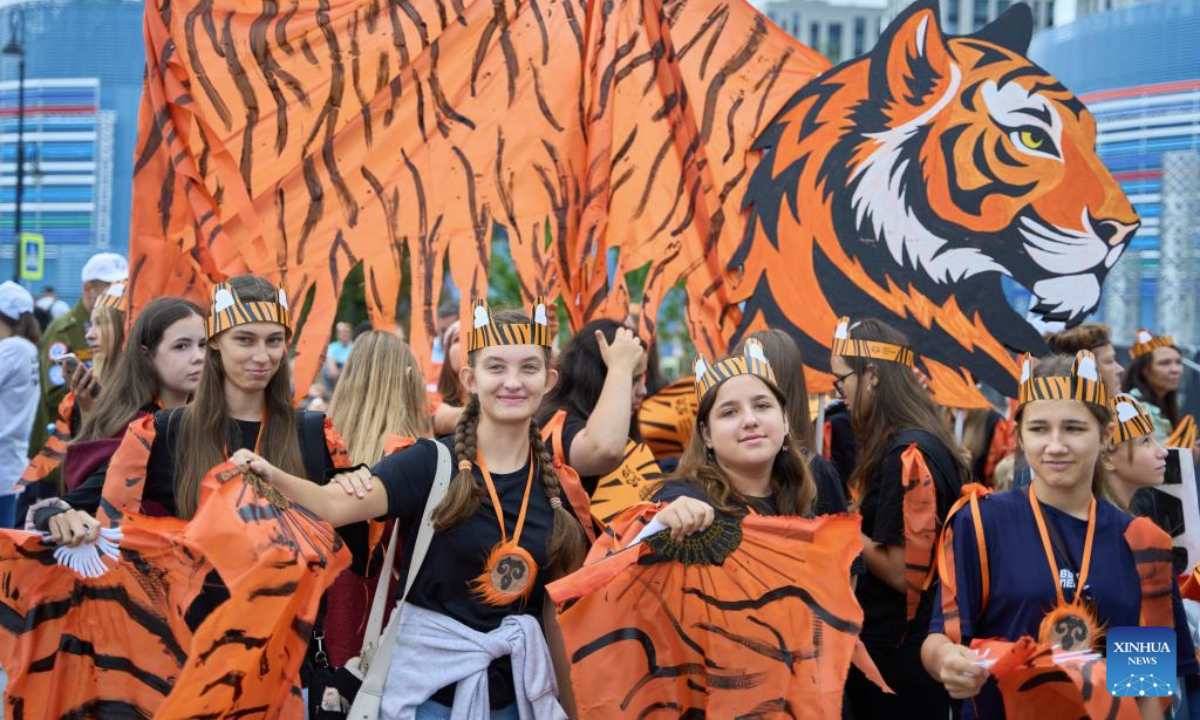 People participate in the Tiger Day costume parade in Vladivostok, Russia, Sept. 28, 2025. Since 2000, Vladivostok has celebrated Tiger Day in the last weekend of September each year to raise public awareness about tiger conservation. (Photo by Guo Feizhou/Xinhua)