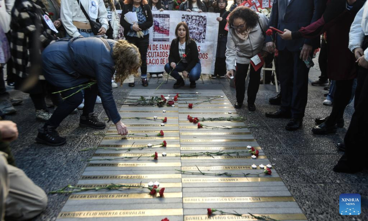 People attend an event to pay homage to former Chilean President Salvador Allende and to commemorate the 52nd anniversary of the military coup against Allende, near La Moneda Palace in Santiago, capital of Chile, Sept. 11, 2025. Then-Commander-in-chief of the Chilean army Augusto Pinochet launched a military coup to overthrow the democratically-elected government of Allende on Sept. 11, 1973. Allende was killed during the coup, marking the beginning of a 17-year period of military regime in Chile. (Photo by Jorge Villegas/Xinhua)