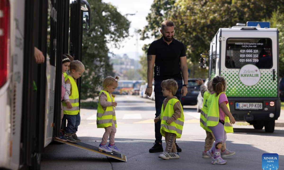 Children learn what they need to know as public transport passengers on World Car Free Day in Ljubljana, Slovenia, Sept. 22, 2025. (Photo by Zeljko Stevanic/Xinhua)