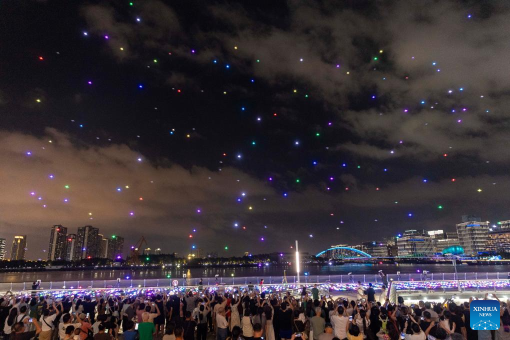 People enjoy a drone light show during the 2nd Shining Shanghai festival in Shanghai, east China, Sept. 19, 2025. The opening ceremony of the festival was held here on Friday. The one-month festival with one main venue and 16 sub-venues features 177 theme activities of shining feast. (Xinhua/Wang Xiang)