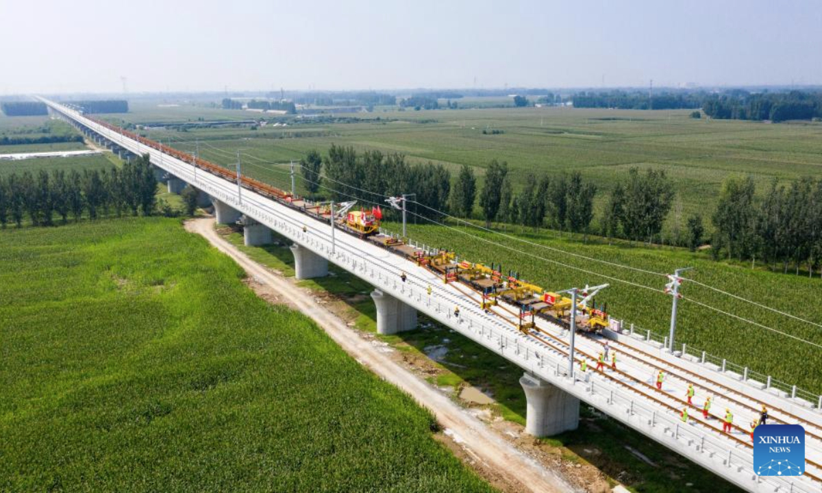 A drone photo taken on Sept. 1, 2025 shows workers operating at the track laying construction site of the Xiong'an-Shangqiu high-speed railway in Hejian city, north China's Hebei Province. Track-laying operation officially kicked off on Monday throughout the Xiong'an-Shangqiu high-speed railway. With a designed speed of 350 km per hour, the 552-kilometer-long railway will connect Xiong'an in north China's Hebei Province and Shangqiu in central China's Henan Province after completion. (Photo by Yuan Ruiyu/Xinhua)