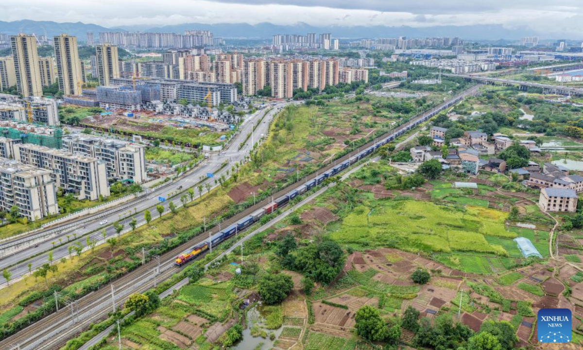 A drone photo taken on Sept. 8, 2025 shows a China-Europe freight train departing from the Tuanjiecun Station in southwest China's Chongqing. From January to July this year, the China-Europe freight train from southwest China's Chengdu and Chongqing has made over 3,400 trips, transporting more than 280,000 twenty-foot equivalent units (TEUs) of import and export goods. (Xinhua/Tang Yi)