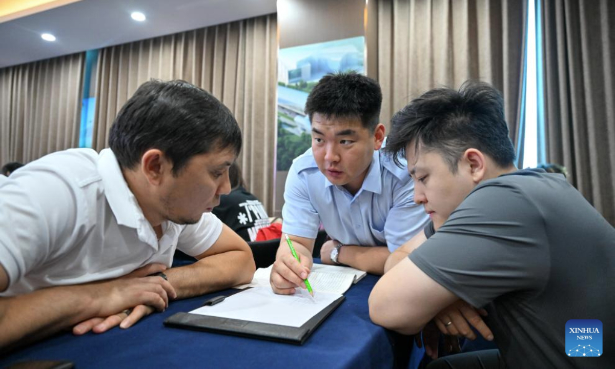 Zhang Yao (C), a trainer from Tianjin Rail Transit, answers questions from Kazakh trainees during a light-rail driver training session in north China's Tianjin Municipality, July 14, 2025. A batch of 29 drivers from Kazakhstan have recently qualified as light-rail drivers after finishing immersive training sessions in China's Tianjin.

Held by Tianjin Rail Transit, the three-month program provided customized technical solutions for driving on a light-rail line in Astana, capital of Kazakhstan. (Xinhua/Sun Fanyue)