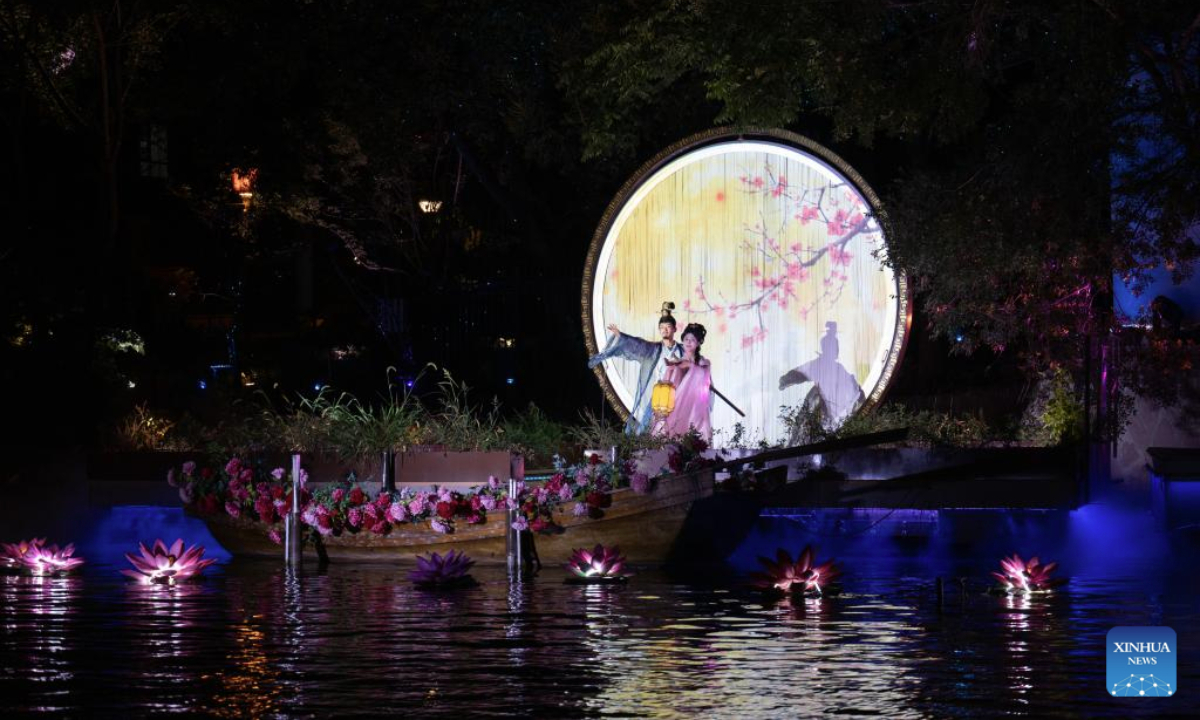 Artists perform along the ancient canal in Wuxi City, east China's Jiangsu Province, Sept. 23, 2025. The Qingming bridge historical and cultural community spreads across the ancient canal, and boasts rich heritages. It is attracting an increasing number of visitors as more modern technologies have been adopted for enhanced sensory experiences. (Xinhua/Hu Zhixuan)