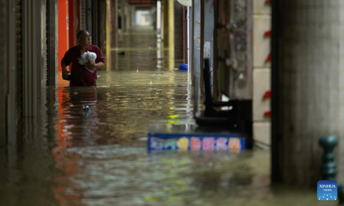 A citizen wades in flood water on a street in Macao, south China, Sept. 24, 2025. Super typhoon Ragasa passed within 100 km of the Macao Special Administrative Region (SAR) on Wednesday morning, causing gale and heavy rain, said Macao's meteorological bureau, which hoisted the No. 10 tropical cyclone signal at 5:30 a.m. local time. (Xinhua/Cheong Kam Ka)