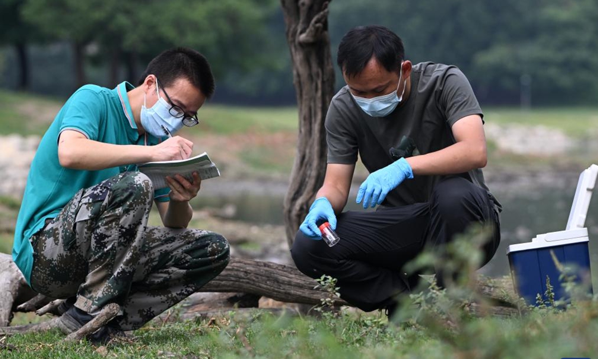 Researchers of the National Conservation and Research Center for Milu collect samples at Milu Park in Beijing, capital of China, Aug. 18, 2025. (Xinhua)
