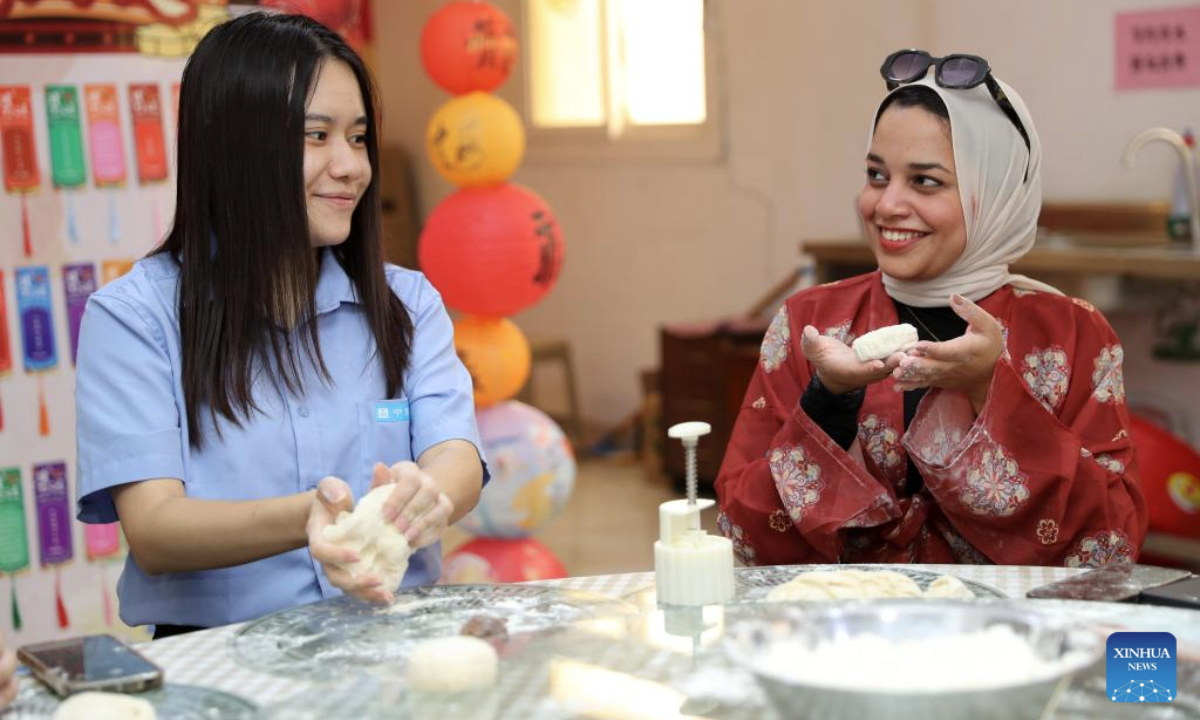 Workers make moon cakes during a Mid-Autumn Festival celebration at the Central Business District (CBD) in the New Administrative Capital, east of Cairo, Egypt, on Sept. 28, 2025. The Egyptian branch of China State Construction Engineering Corporation (CSCEC) on Sunday held an event to celebrate the upcoming traditional Chinese Mid-Autumn Festival at the CSCEC-built CBD, where CSCEC's workers from China and Egypt experience rich festival cultures, such as the making of traditional Chinese lanterns and moon cakes. (Xinhua/Sui Xiankai)