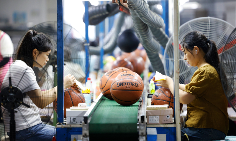 Staff work on basketballs for export orders at a factory in the Sihong Economic Development Zone in Sihong county, East China's Jiangsu Province, on September 12, 2025. This year, numerous sports enterprises in the zone have secured orders for footballs, basketballs, and other sports goods, meeting robust domestic and international consumer demand. Photo: VCG