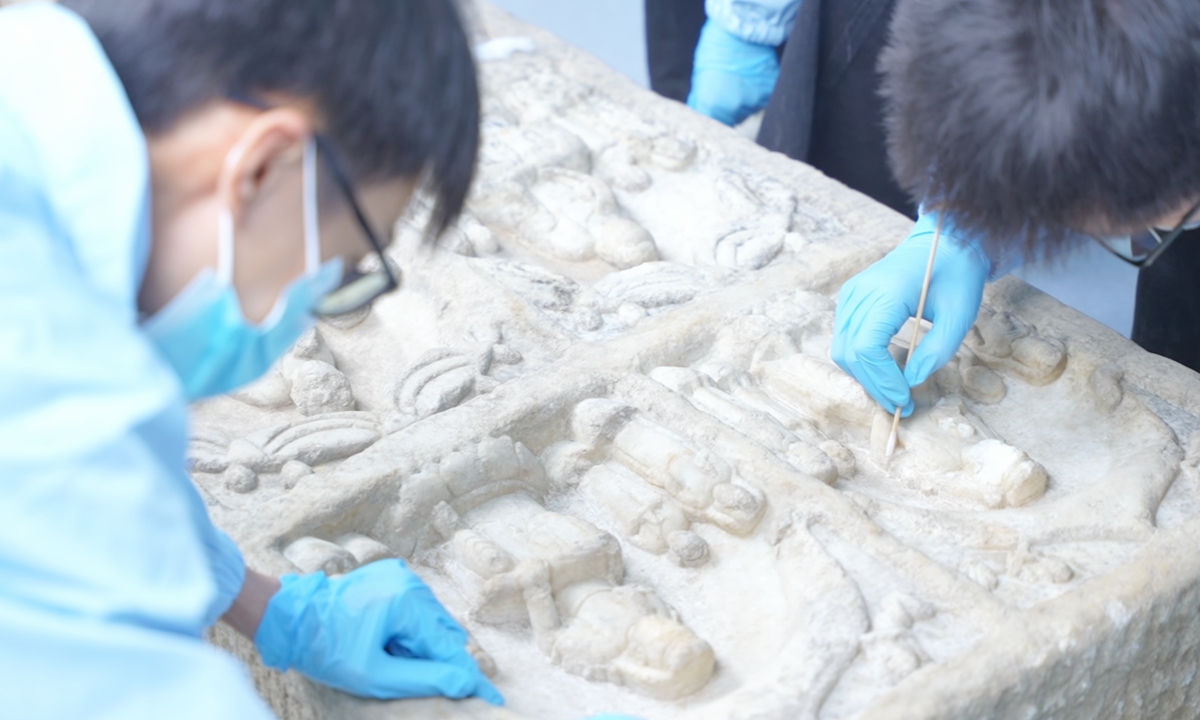 Researchers work at the Longmen Grottoes heritage scientific conservation center. Photo: Courtesy of the Longmen Grottoes Academy