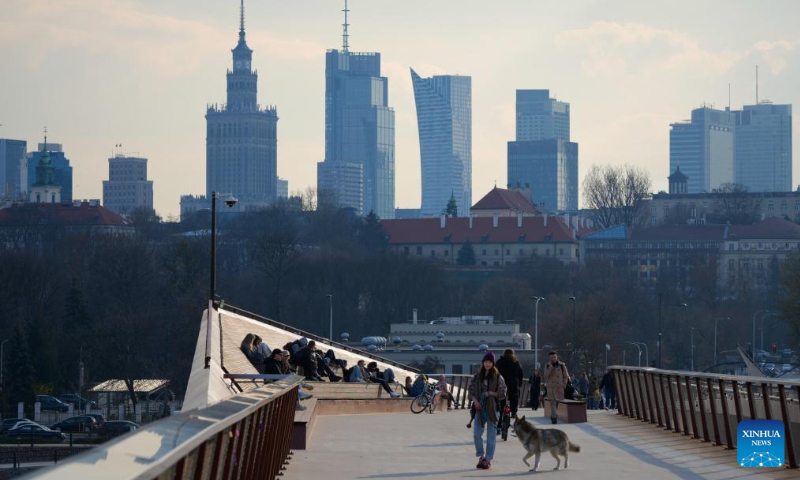 People are seen on a pedestrian bridge over the Vistula River in Warsaw, Poland on March 25, 2025. Photo: Xinhua