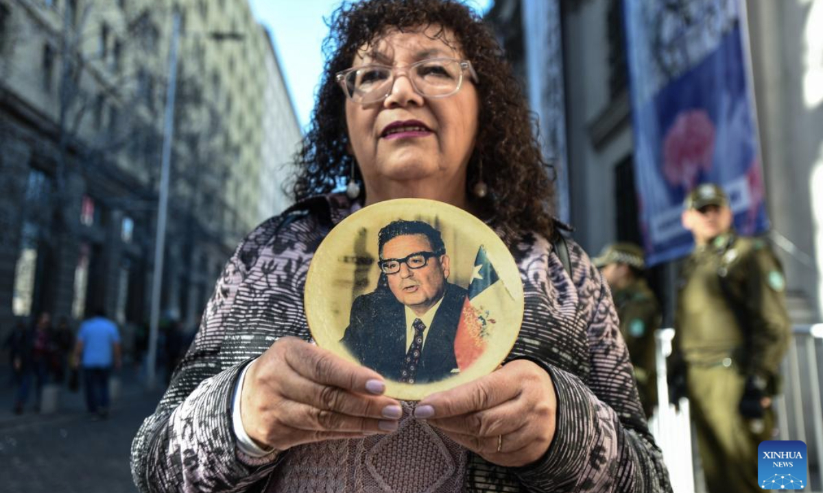 A woman attends an event to pay homage to former Chilean President Salvador Allende and to commemorate the 52nd anniversary of the military coup against Allende, near La Moneda Palace in Santiago, capital of Chile, Sept. 11, 2025. Then-Commander-in-chief of the Chilean army Augusto Pinochet launched a military coup to overthrow the democratically-elected government of Allende on Sept. 11, 1973. Allende was killed during the coup, marking the beginning of a 17-year period of military regime in Chile. (Photo by Jorge Villegas/Xinhua)