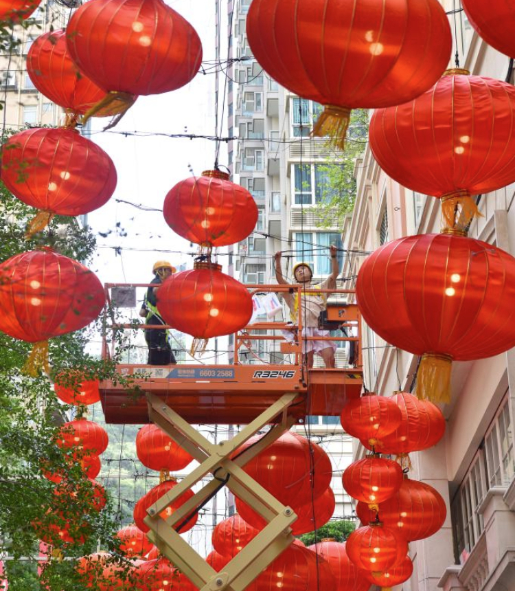 Staff members hang decorative lanterns in south China's Hong Kong, Sept. 28, 2025. With the approach of National Day and the Mid-Autumn Festival, the streets of Hong Kong are adorned with festive decorations. (Xinhua/Chen Duo)